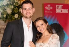 Tom Leach standing with his wife Mia McKenna-Bruce at a formal public event.