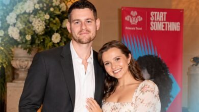 Tom Leach standing with his wife Mia McKenna-Bruce at a formal public event.